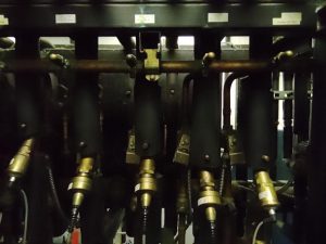 Close-up of industrial refrigeration system valves and copper piping.